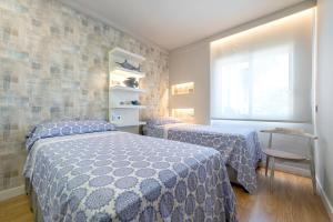 a bedroom with two beds and a window at La Rosaleda in Miami Platja +19 photos