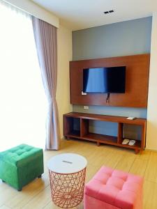 a living room with a flat screen tv and a couch at INNCITY HOTEL in Calbayog City