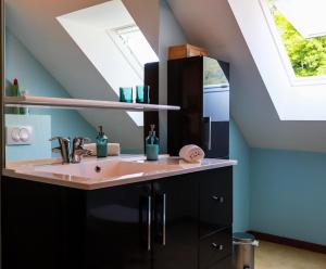 a bathroom with a sink and a skylight at L'Écrin Vue Lac 3 étoiles - Parking gratuit, Calme & confort in Sévrier +44 photos