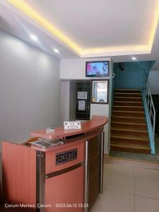 a lobby with a reception counter and a staircase at Şirin Apart in Corum