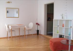 ein Wohnzimmer mit einem weißen Tisch und Stühlen in der Unterkunft Ferienwohnung Weitsicht in Gleiszellen-Gleishorbach