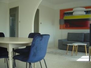 a living room with a table and chairs and a couch at VILLA MI-JO in Forcalquier