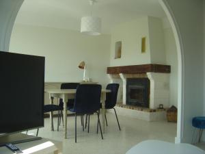 a dining room with a table and a fireplace at VILLA MI-JO in Forcalquier