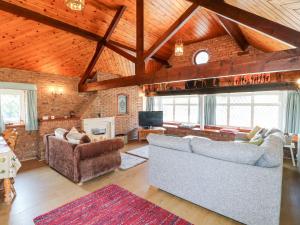 a living room with two couches and a fireplace at Elm Tree Cottage in Melton Mowbray