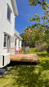 une terrasse avec deux chaises et un banc sur une maison dans l'établissement Ellös Holiday apartment, à Ellös