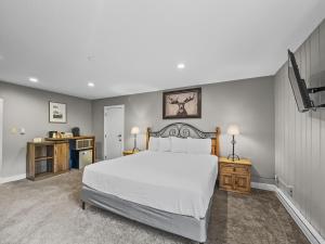 a bedroom with a large white bed and two tables at CM321H Copper Mtn Inn Hotel Room in Copper Mountain