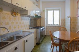 a kitchen with a table and a sink and a table and chairs at Da Tina in Portoferraio