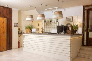 a bar in a restaurant with pendant lights at Hotel Magdalena in Pefkochori