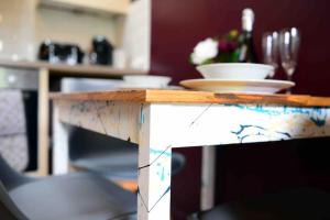 a wooden table with plates on top of it at 1 Bedroom Apartment -Sleeps 3- Big Savings On Long Stays! in Kent