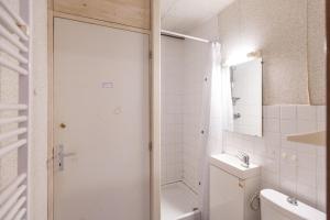 a bathroom with a shower and a toilet and a sink at Appartement Pieds des Pistes in Saint-Lary-Soulan +20 photos