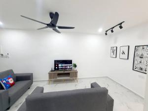 a living room with a couch and a ceiling fan at (New)Jovial Cozy&Stylish House 4Room@BM Sri Rambai in Bukit Mertajam