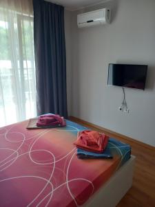 a room with a bed with two bags on it at Santa Maria Apartments in Ahtopol