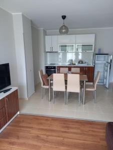 a kitchen and dining room with a table and chairs at Santa Maria Apartments in Ahtopol