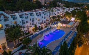 an aerial view of a resort with a pool at night at Aparthotel Holiday Center in Santa Ponsa