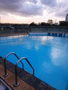 a large swimming pool with blue water at Emeli Suites in Nairobi