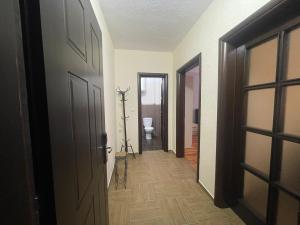 a hallway with a door and a toilet in a room at Leones Villa in Pogradec +1 photo