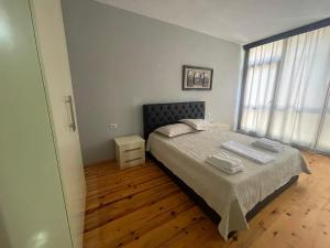 a bedroom with a bed with two towels on it at Leones Villa in Pogradec