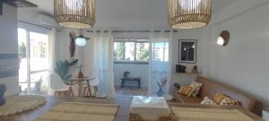 a living room with a table and a dining room at Apartamento el Boquerón 3 in Torre del Mar +11 photos