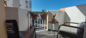 a balcony with potted plants on a building at Apartamento el Boquerón 3 in Torre del Mar