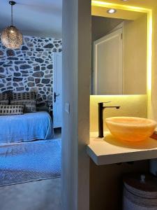 a bathroom with a sink and a bedroom with a bed at Gare du Nord in Sant Joan de Labritja