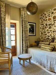 a bedroom with a bed and a stone wall at Gare du Nord in Sant Joan de Labritja