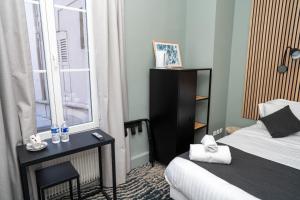 a hotel room with a bed and a window at l'itinerance in Mers-les-Bains