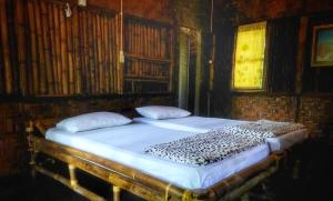 a large bed in a room with at ETALAUSER Jungle Gate EcoResort Bukit Lawang in Bukit Lawang