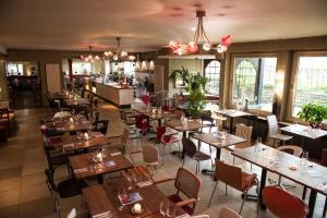 a restaurant with tables and chairs and a bar at Dieckmann's Hotel in Dortmund