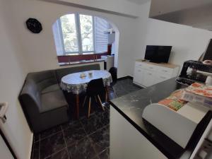 a kitchen with a couch and a table in a kitchen at Apartment Serkyovi in Pomorie