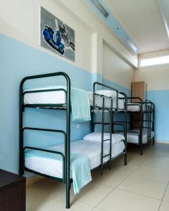 a group of bunk beds in a room at Eliopoli Beach Hostel & Restaurant in Tirrenia