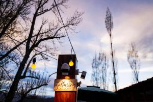 a wooden pole with lights on it with trees in the background at Rainbow Hostelier in Leh