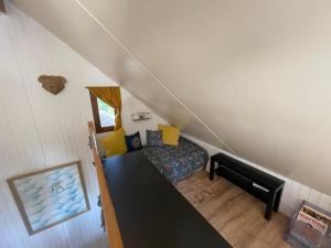 a small room with a bed in a attic at Chalet confort • Barcelonnette in Barcelonnette
