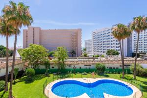 una gran piscina en un parque con palmeras en Imperial Puerto 2 3F By IVI Real Estate, en Torremolinos