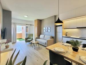 a living room and dining room with a dining table at The Valley View Apartments in La Orotava