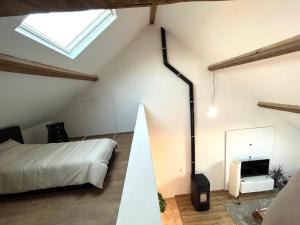 Dormitorio en el ático con cama y espejo en L'escale en Enghien