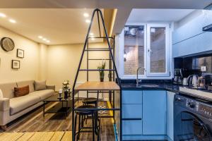 a kitchen and living room with blue cabinets and a ladder at Centrally Located Flat in Sisli İstanbul in Istanbul