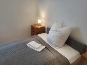 a bed with a pillow and a napkin on it at Apartment Pette C40 in Berlin