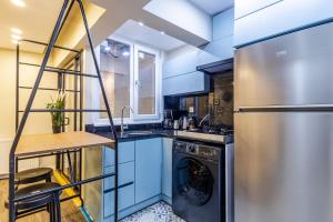 a kitchen with blue cabinets and a dishwasher at Centrally Located Flat in Sisli İstanbul in Istanbul