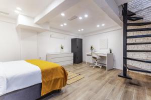 a bedroom with a bed and a desk and a chair at Centrally Located Flat in Sisli İstanbul in Istanbul