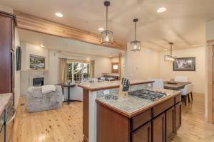 an open kitchen and living room with a counter top at Bavarian Mountain Suite Condo by NW Comfy Cabins in Leavenworth