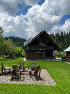 a picnic table and chairs in front of a building at Guest House in Slavske
