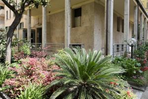 a garden in front of a building with plants at Suite RHome In Vatican in Rome