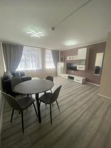 a large living room with a table and chairs at Jackson Holiday Apartments in Blackpool