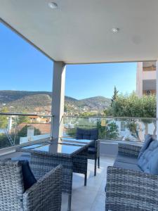 a balcony with a table and chairs and a view at Porto Rafti Dream Complex & Retreat in Porto Rafti