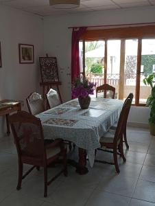 una mesa de comedor con sillas y un jarrón. en Tara Casa Rural en Cartagena
