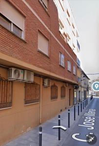 an empty street in front of a brick building at HOSTER EGYPT VERONA centro de Tomelloso in Tomelloso