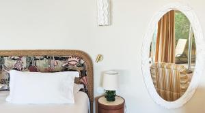 a bedroom with a mirror and a bed at Hôtel La Pérouse Nice Baie des Anges in Nice