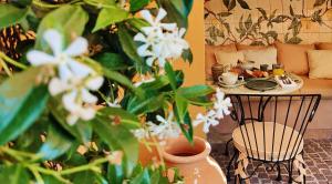 a table with a plate of food and a plant at Hôtel La Pérouse Nice Baie des Anges in Nice