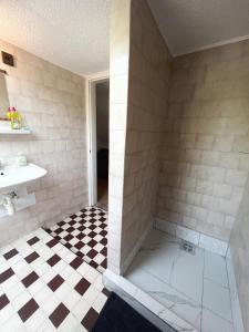 a bathroom with a shower with a checkered floor at Müller's 1 in Siófok
