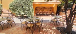 a group of tables and chairs in a courtyard at Hôtel La Pérouse Nice Baie des Anges in Nice
